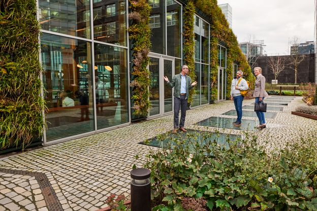 Standing in front of a sustainable building.