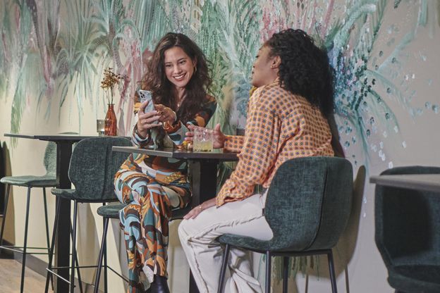 two women talking in a bar